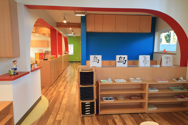 Interior view of Eyas Montessori classroom with art supplies on shelves