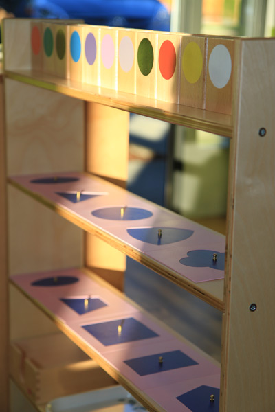 Montessori metal insets activity on a shelf in Eyas Montessori classroom