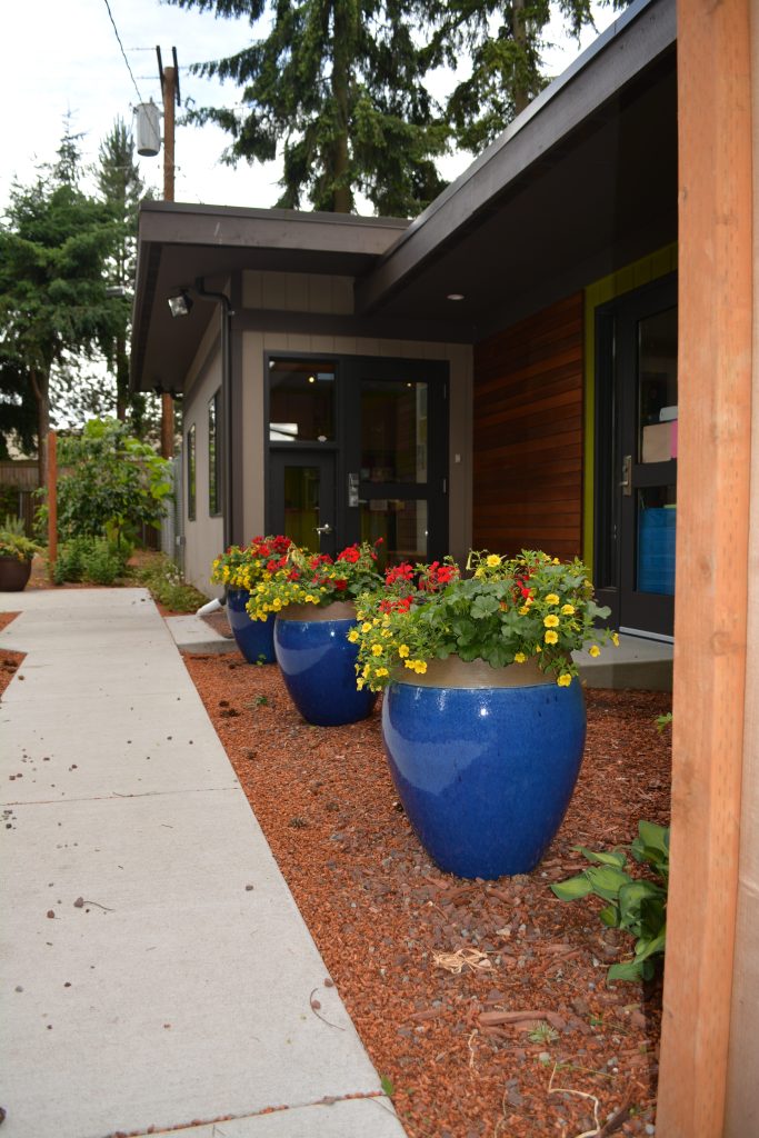 Exterior view of Eyas Montessori front walk with flower planters